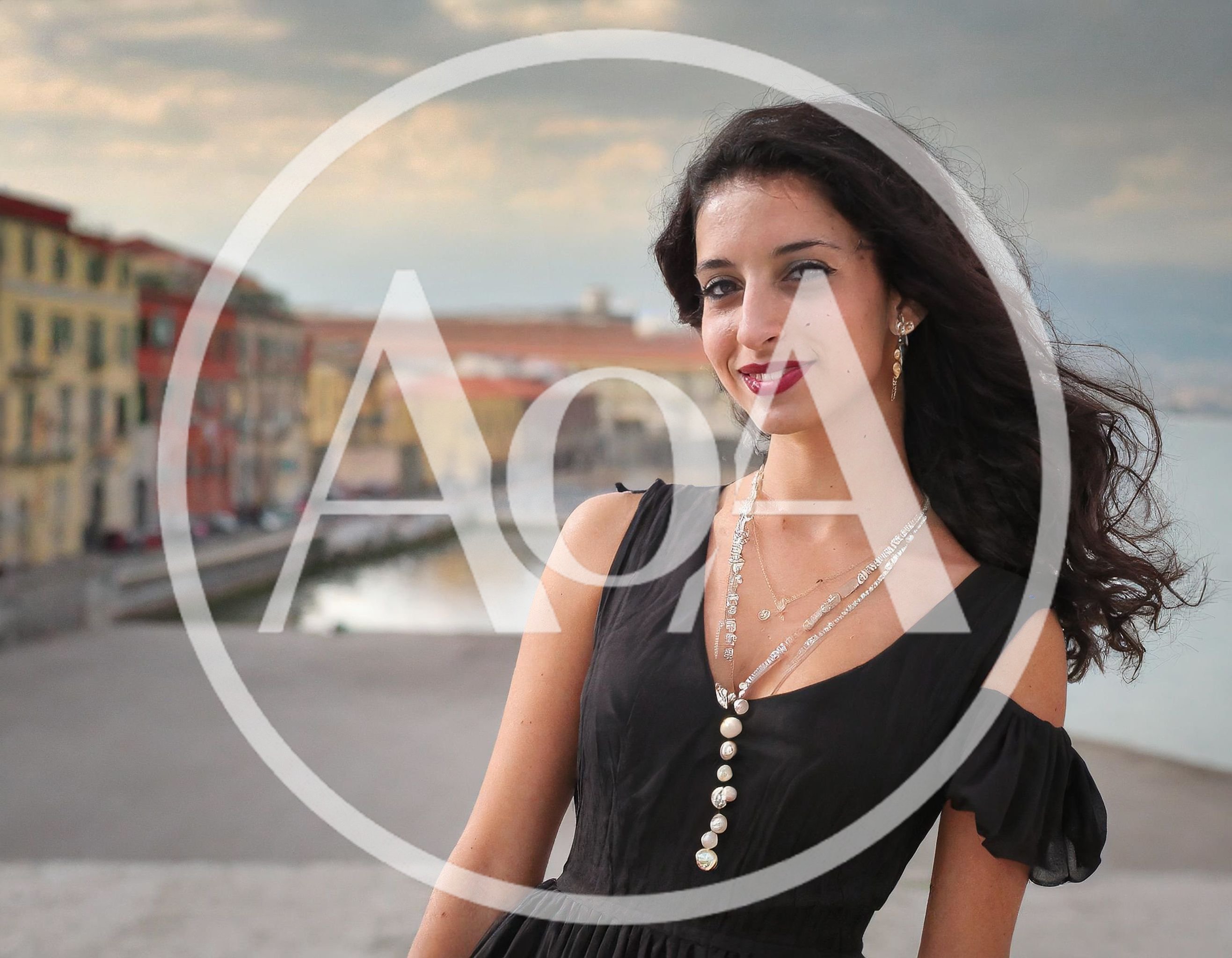 Young Woman Posing In A Black Dress By The River