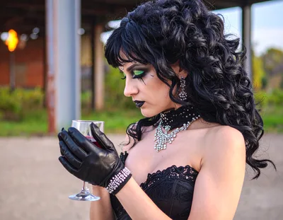 Gothic Woman Holding A Wine Glass In An Industrial Setting