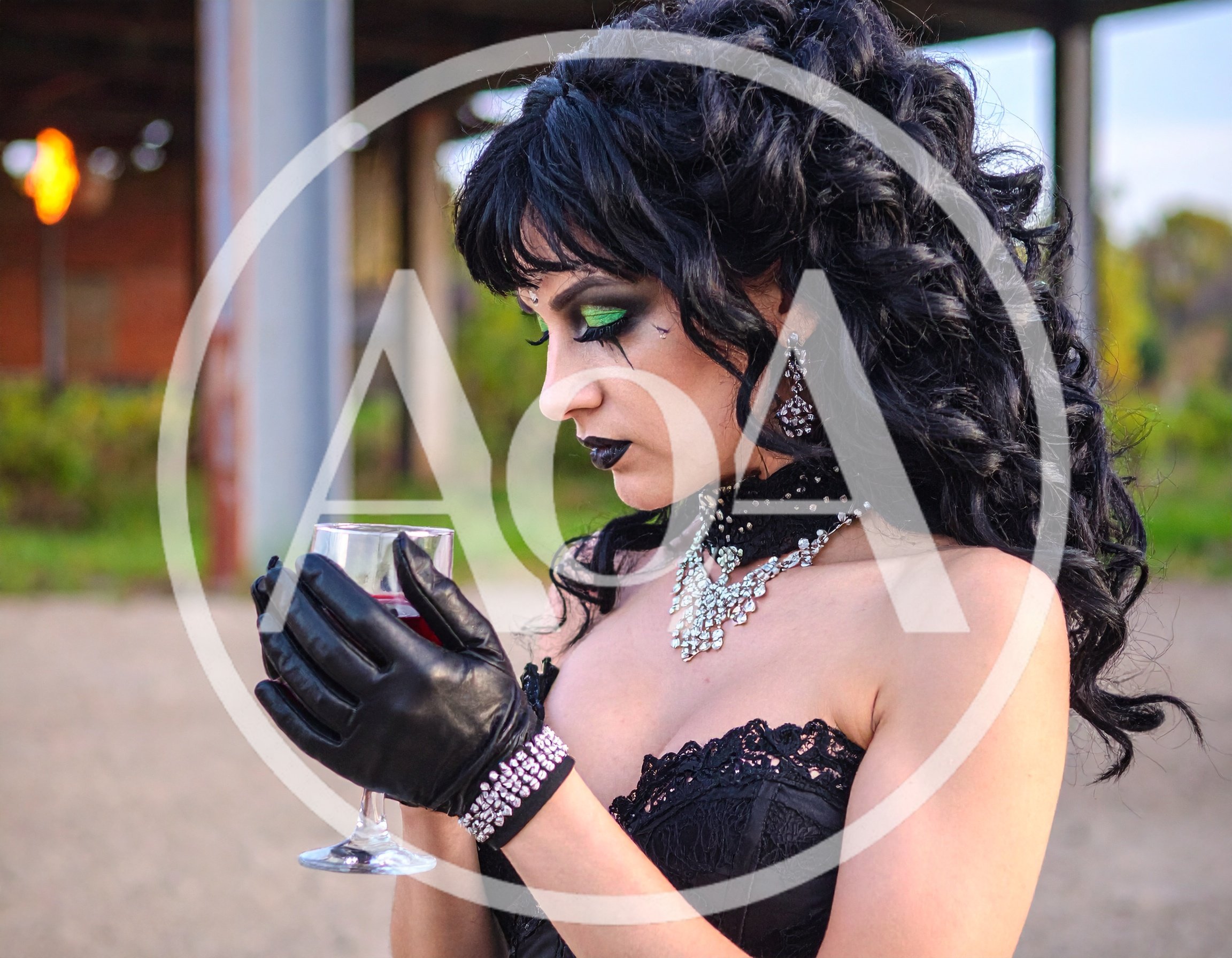 Gothic Woman Holding A Wine Glass In An Industrial Setting