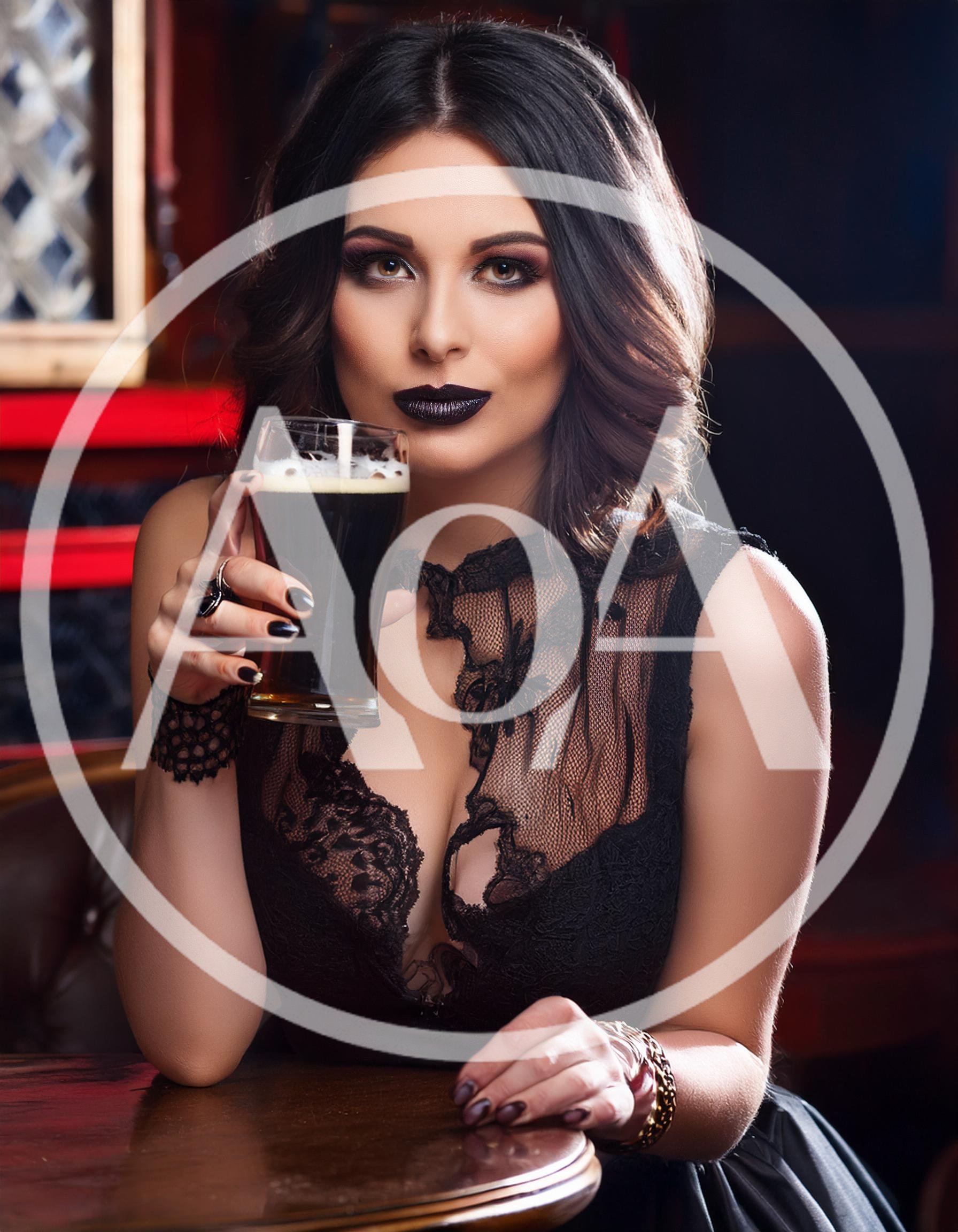 Elegant Woman Holding A Glass Of Dark Beer
