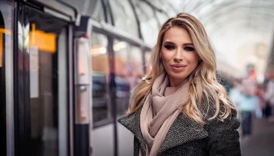 Blonde Woman Standing On A Modern Train Platform
