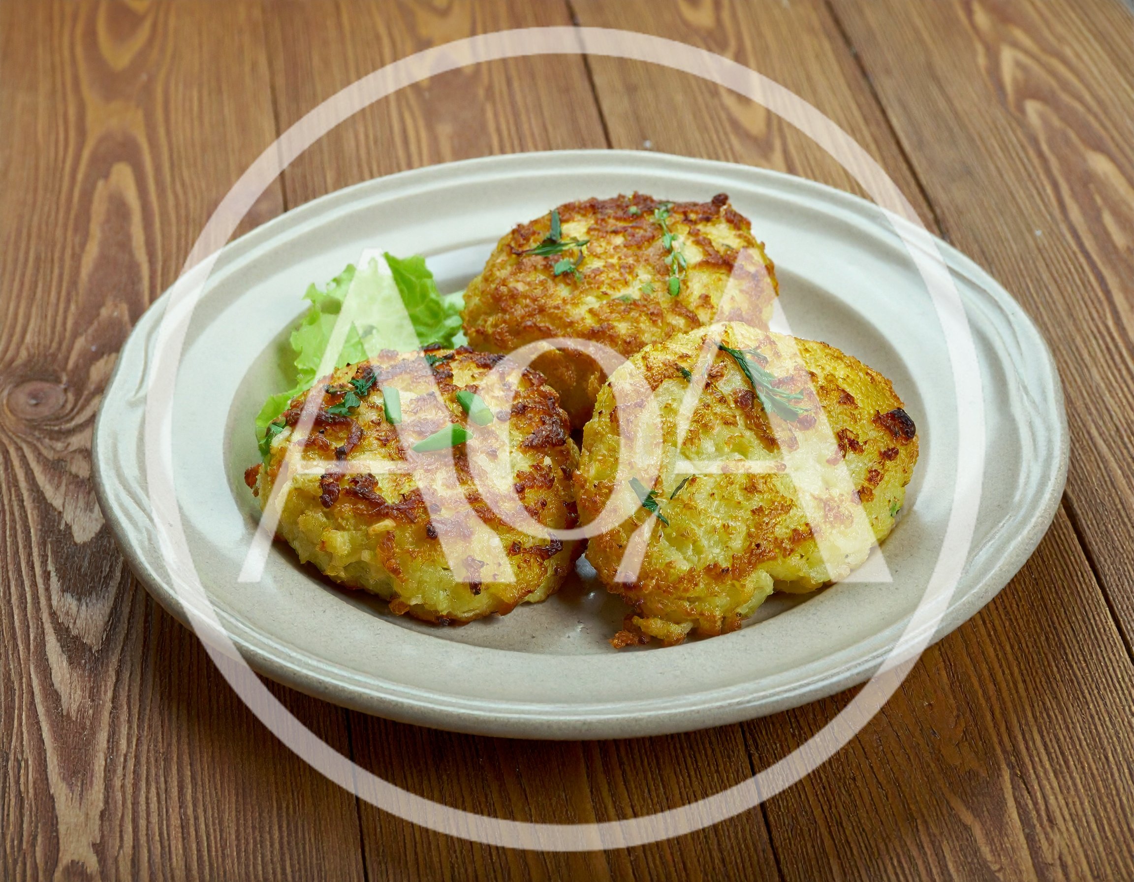 Three Golden Fried Potato Pancakes On A Plate