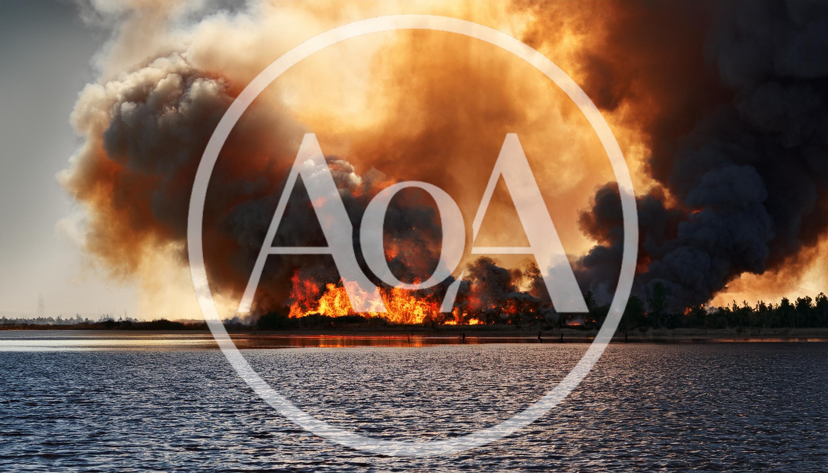 Massive Wildfire Burning Along A Large Lake Shoreline