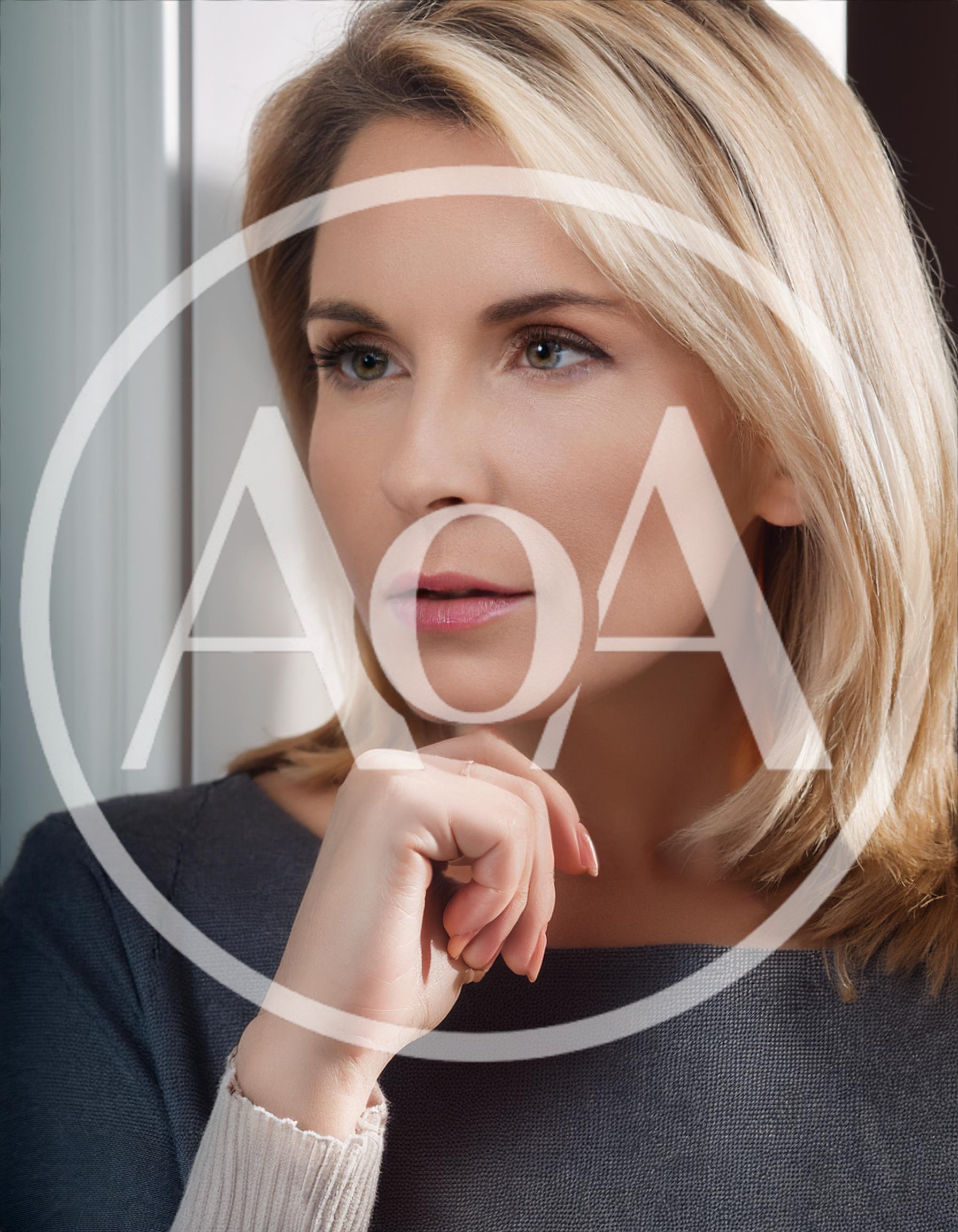 Thoughtful Blonde Woman Resting Chin On Hand