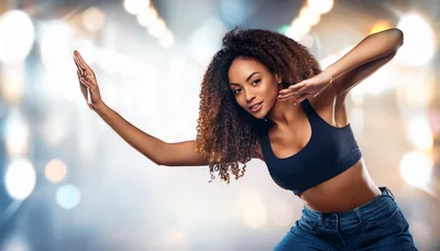Young Woman Dancing With Curly Hair In Studio