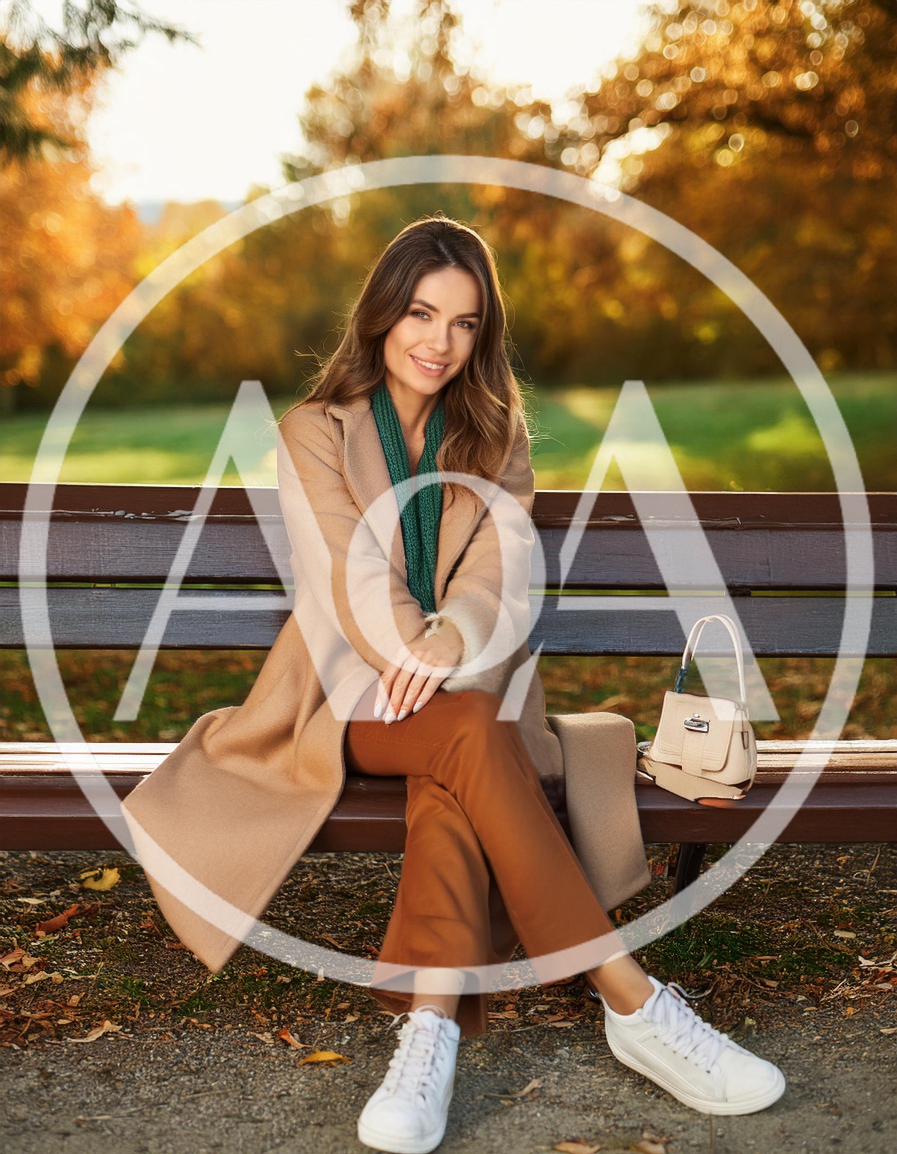 Young Woman Sitting On A Park Bench In Autumn