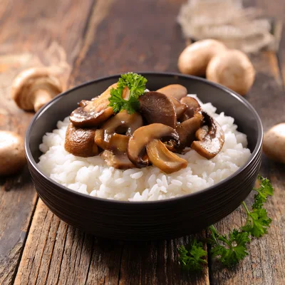 Bowl Of White Rice Topped With Sautéed Mushrooms