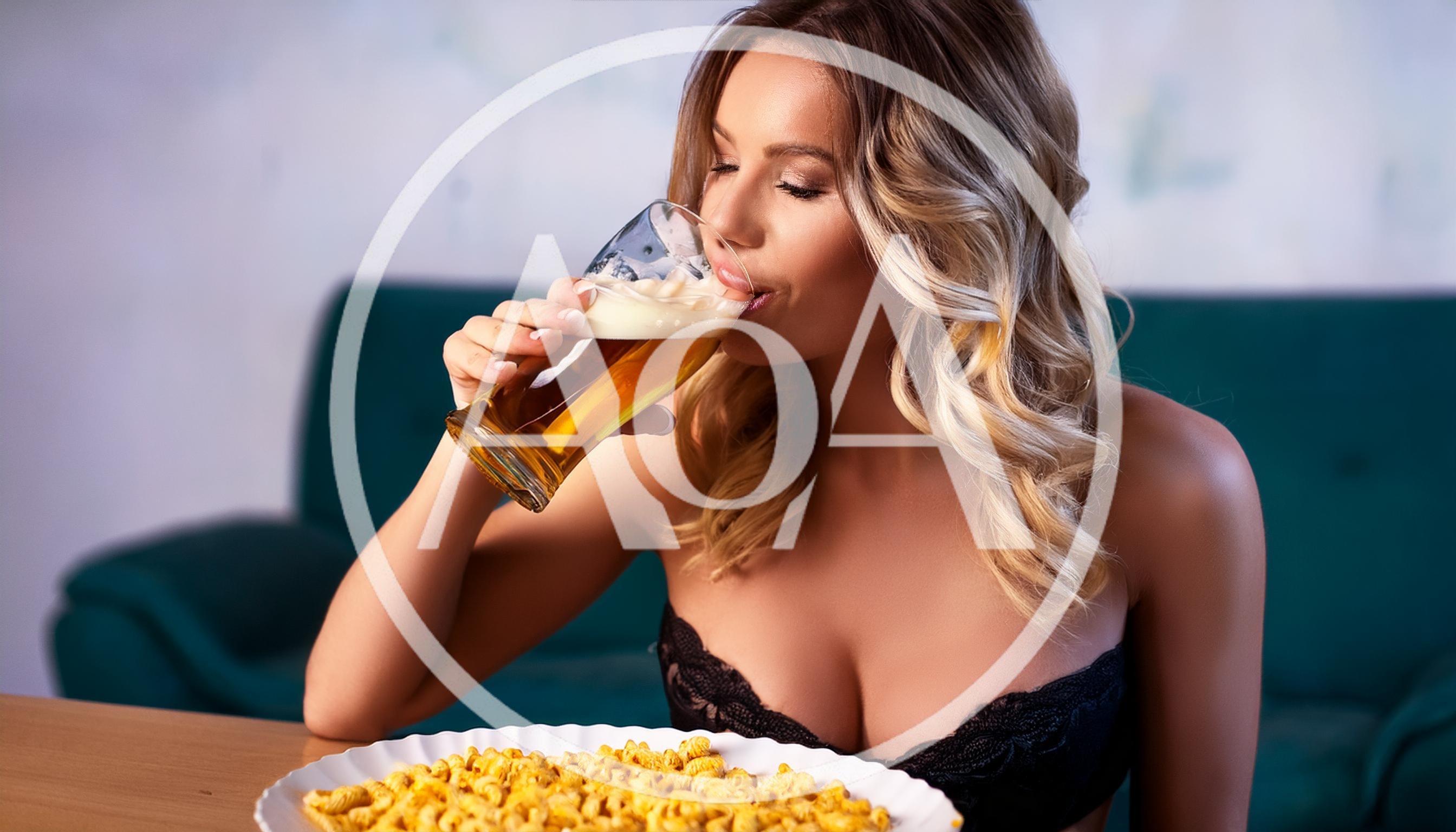 Young Woman Drinking Beer With Popcorn