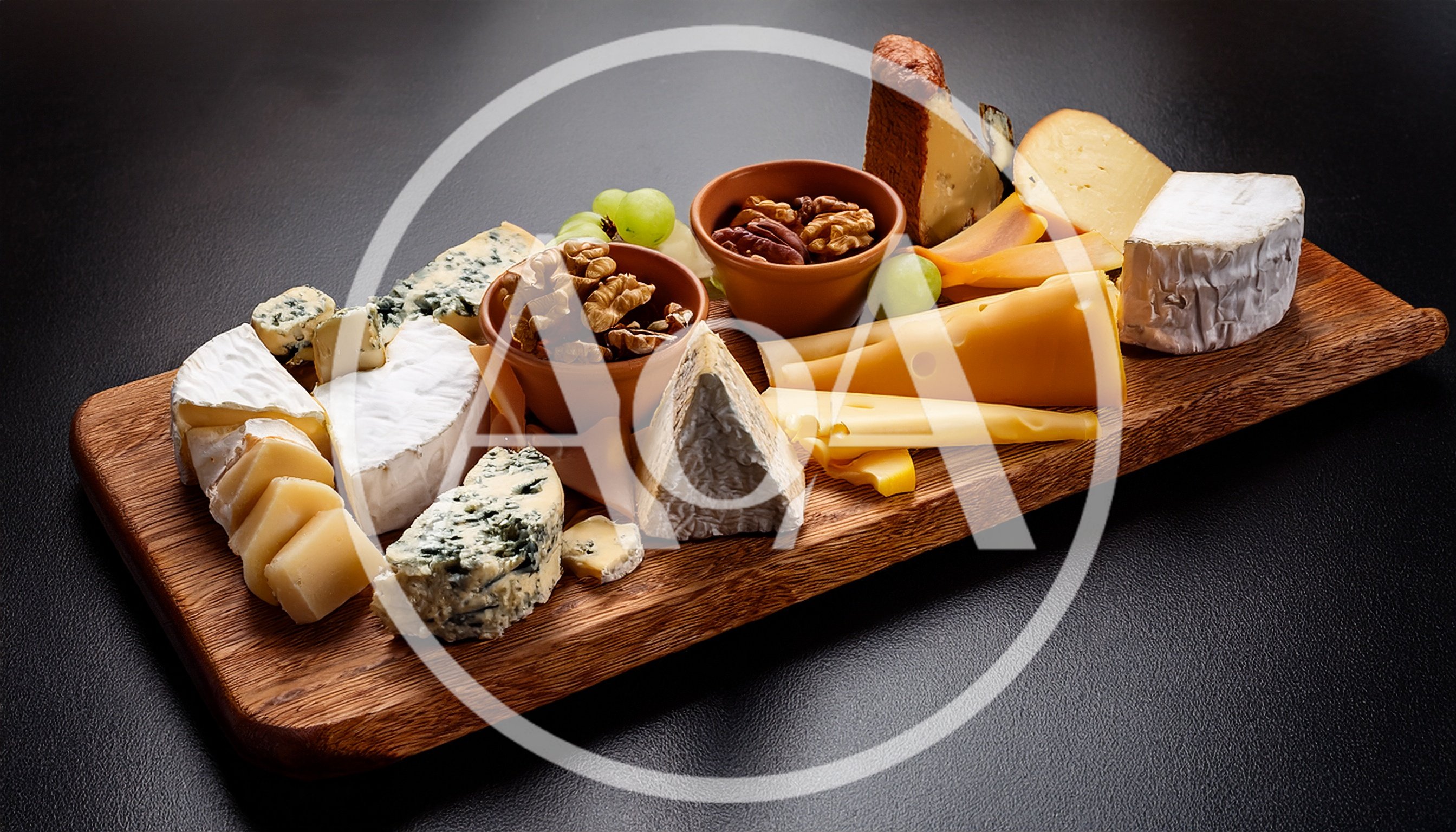 Gourmet Cheese Board With Nuts And Grapes