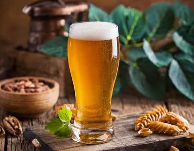 Glass of Golden Beer on Rustic Wooden Table