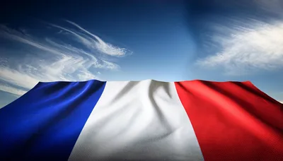Waving French Flag Against A Clear Blue Sky
