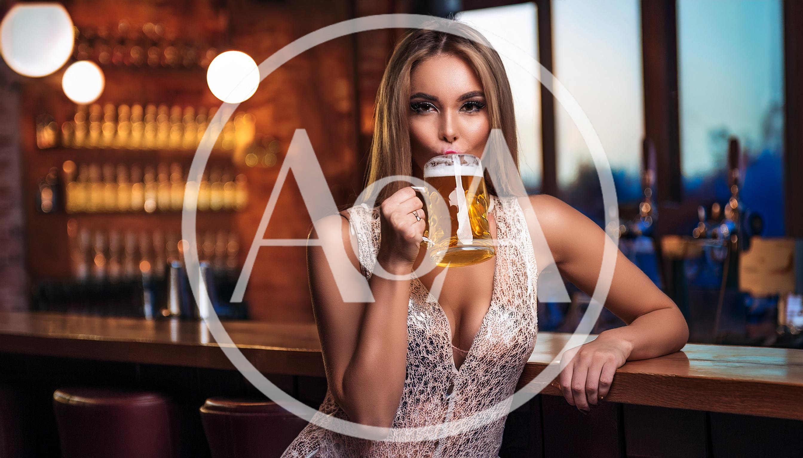 Beautiful Woman Drinking Beer at a Bar Counter