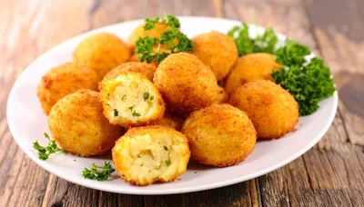 Crispy Fried Potato Croquettes On A White Plate