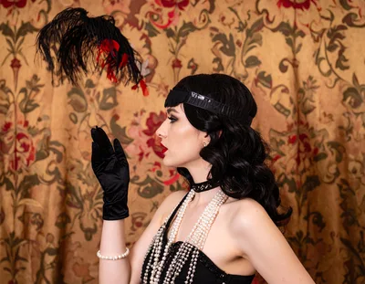 Elegant Woman In 1920s Flapper Costume With Feather