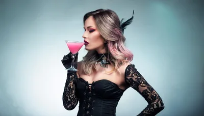 Woman In Gothic Corset Drinking Pink Cocktail