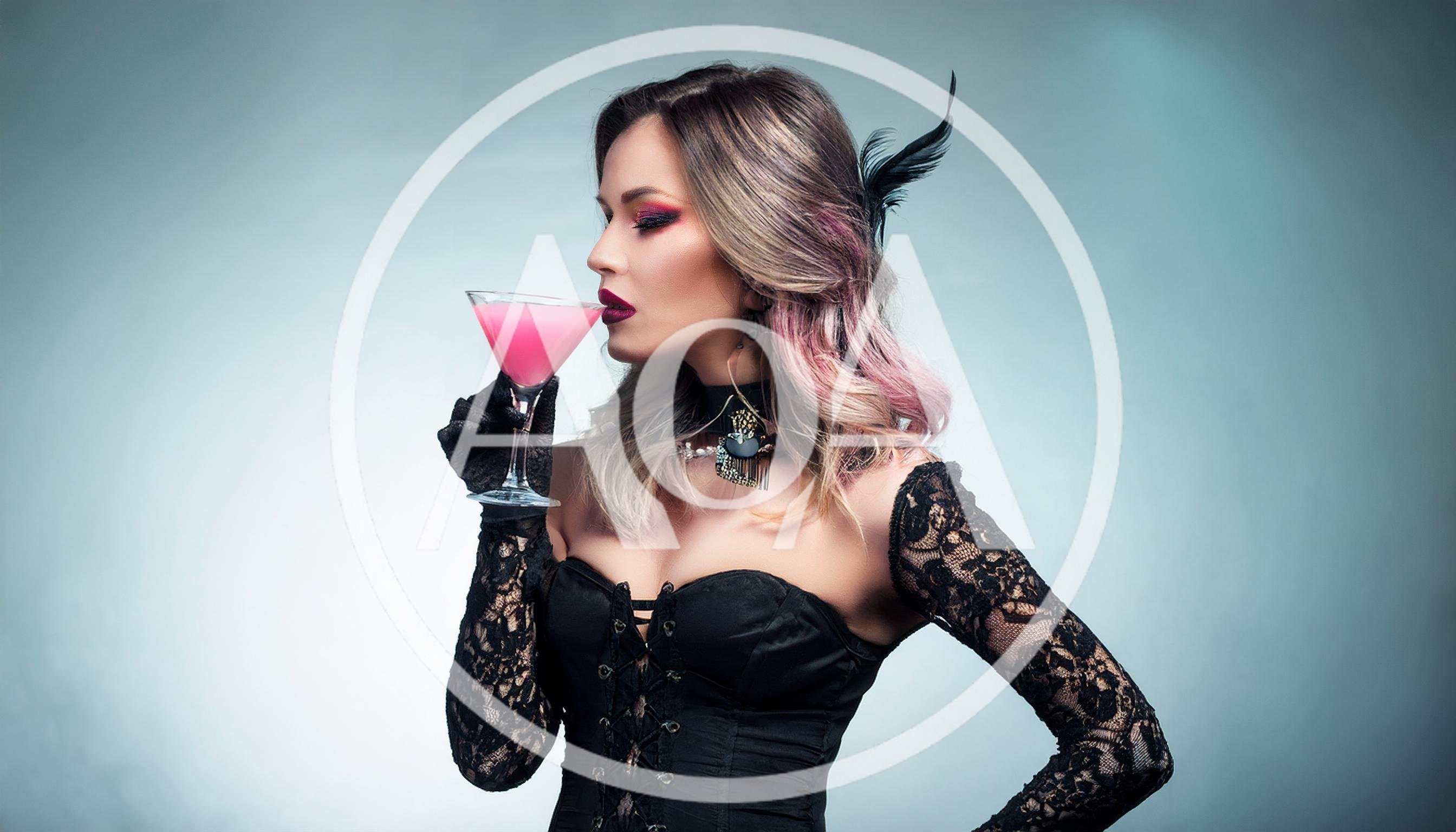 Woman In Gothic Corset Drinking Pink Cocktail