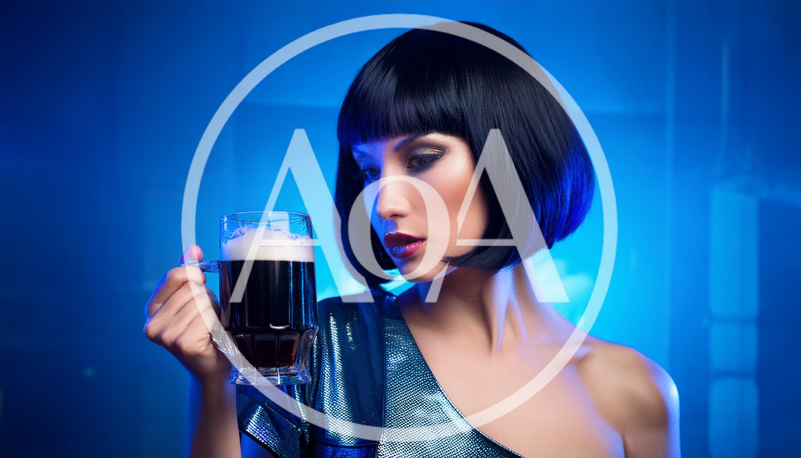 Woman With Bob Haircut Holding A Glass Of Stout