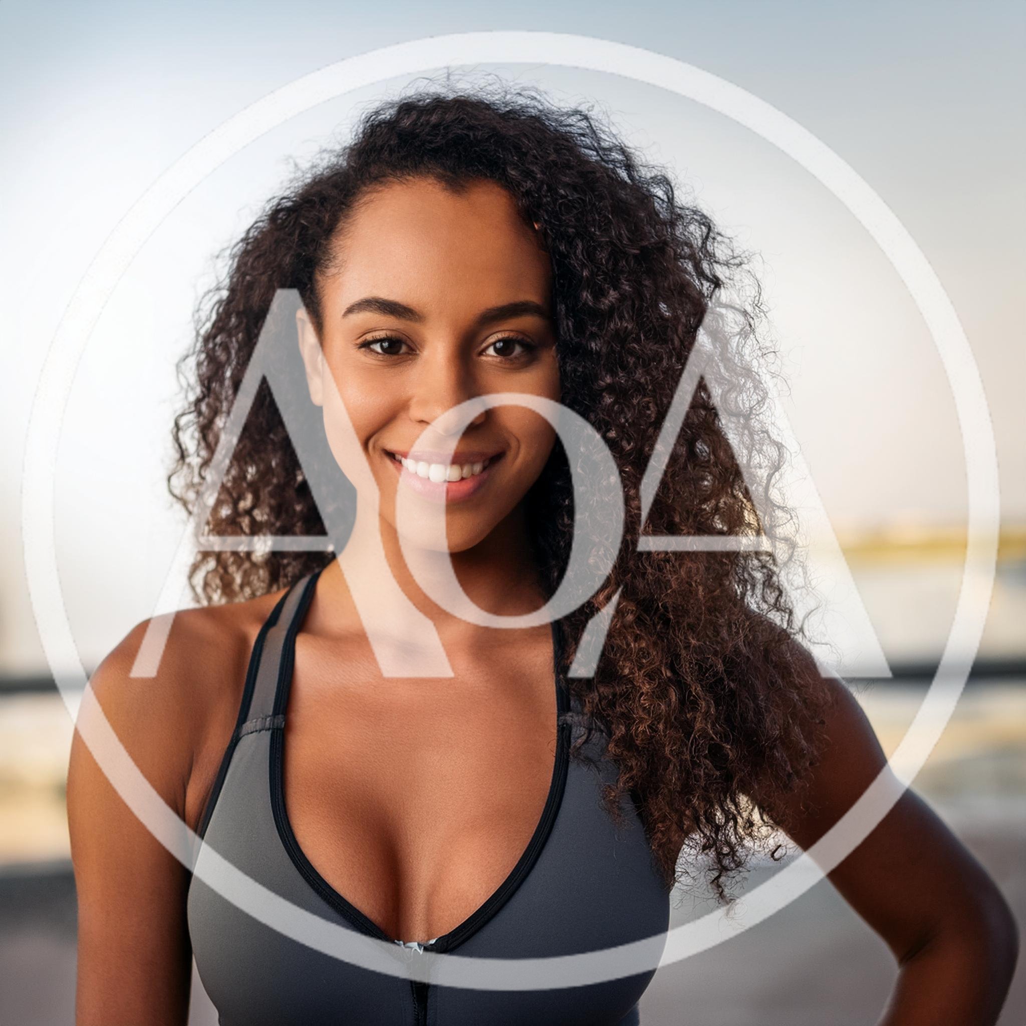 Portrait Of A Smiling Athletic Woman In Sportswear
