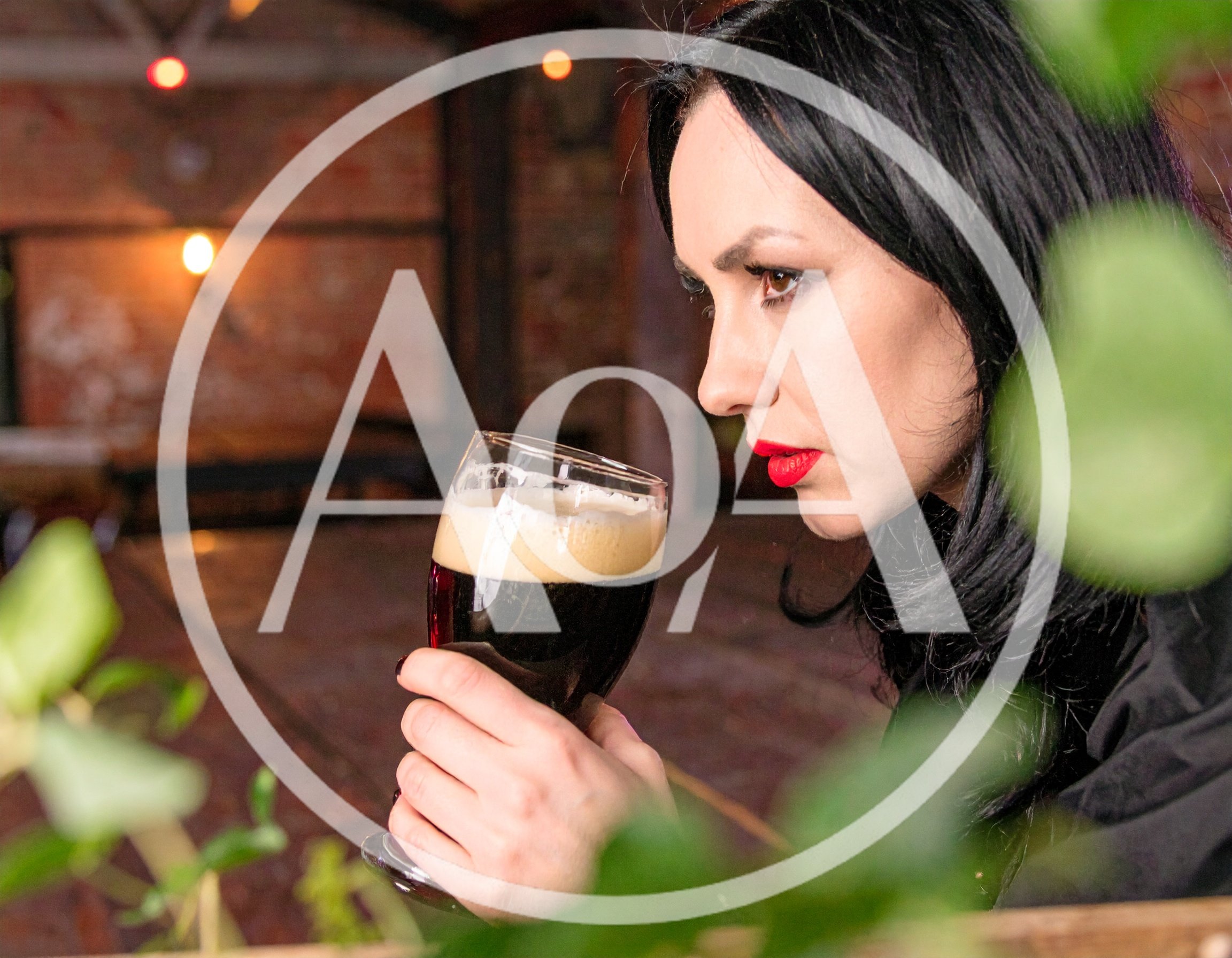 Woman Smelling A Glass Of Dark Craft Beer