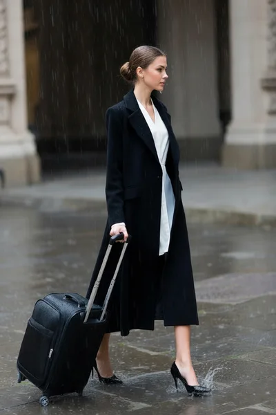 Elegant Woman Walking With Suitcase In The Rain