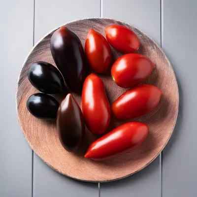 Assorted Heirloom Tomatoes On A Textured Ceramic Plate