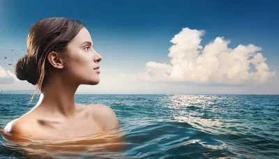 Young Woman Swimming In The Ocean At Sunset