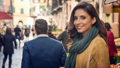 Smiling Woman Walking Through A Bustling Italian Market