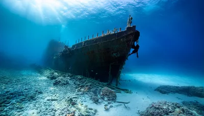 Sunken Shipwreck Resting On The Sandy Ocean Floor