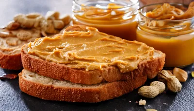 Peanut Butter Spread On Slices Of Toasted Bread