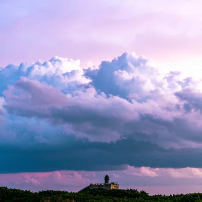 Stone Fortress Tower Under Dramatic Purple Storm Clouds