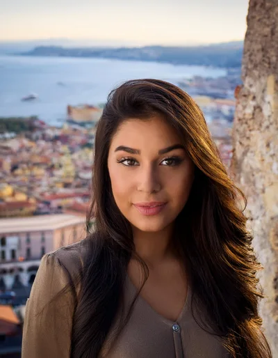 Portrait Of A Young Woman Overlooking A Coastal City