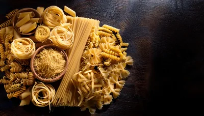 Assorted Dry Pasta Varieties On Dark Wooden Background