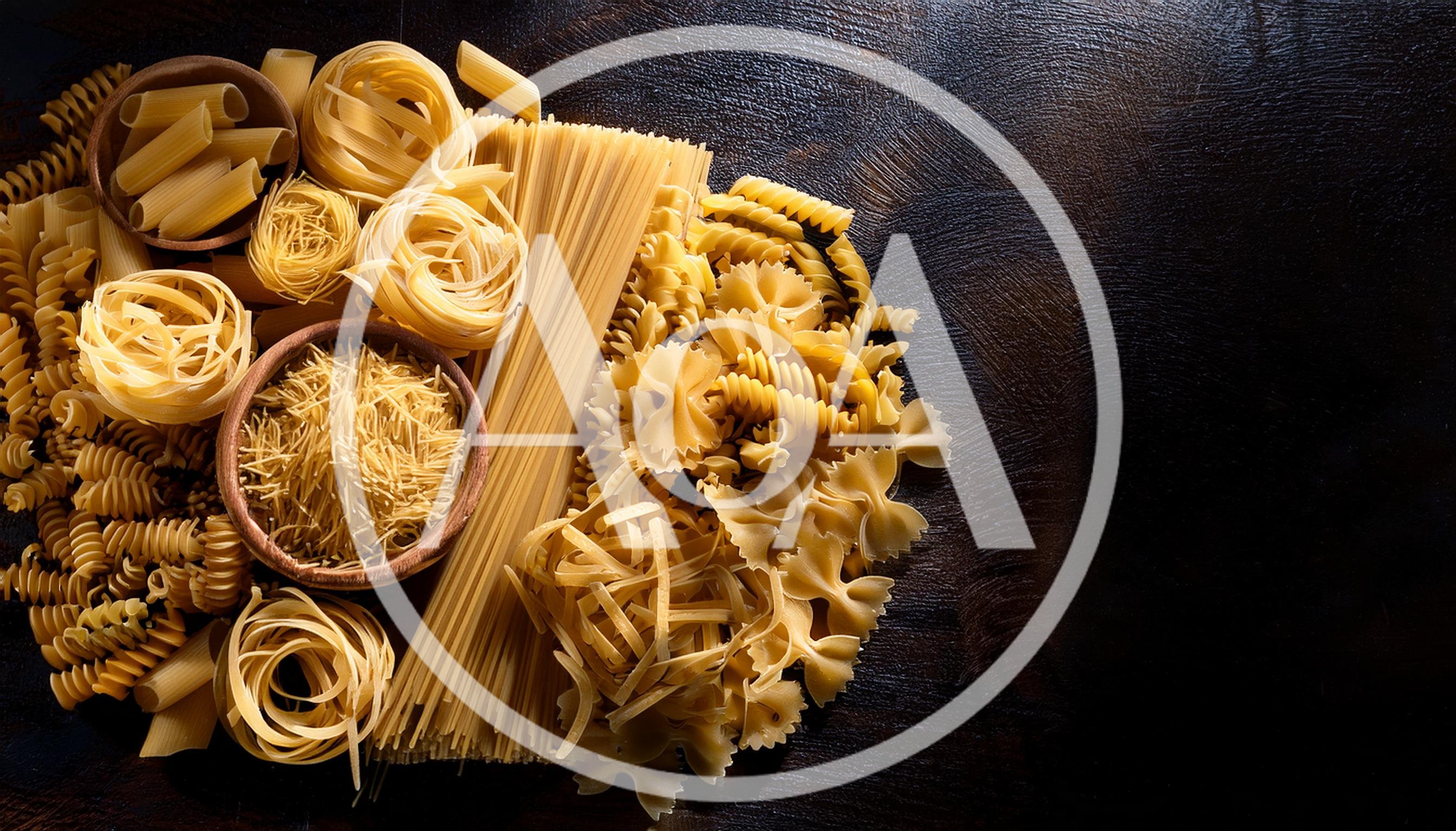 Assorted Dry Pasta Varieties On Dark Wooden Background