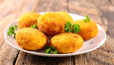 Fried Potato Croquettes On A White Plate