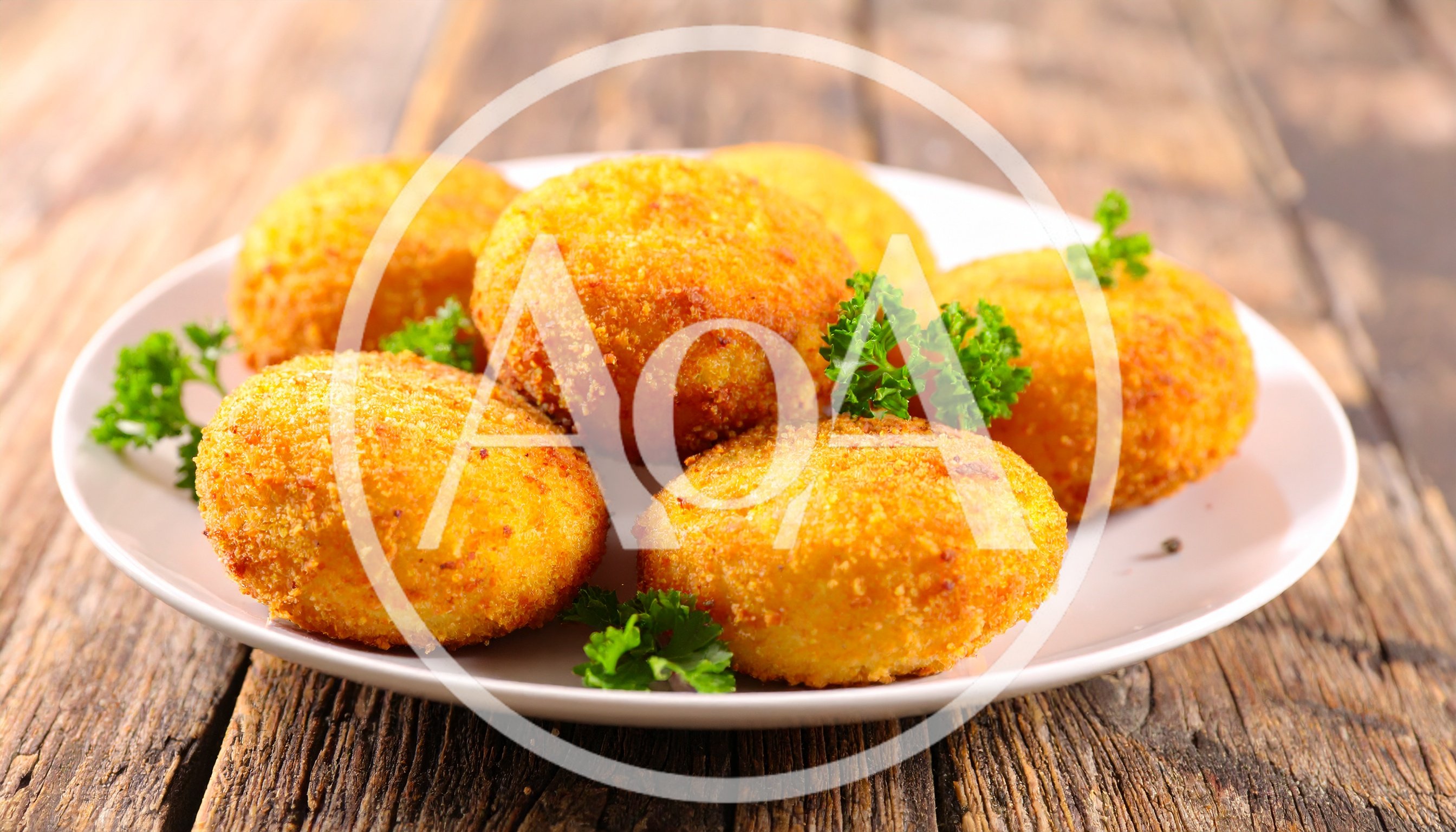 Fried Potato Croquettes On A White Plate