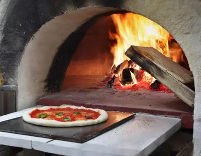 Uncooked Pizza On Peel Before Wood Fired Oven