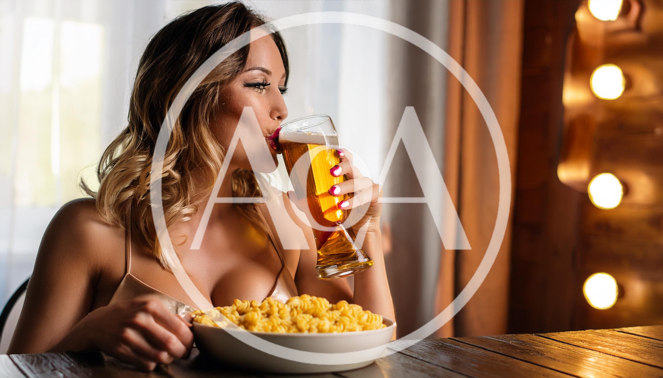 Young Woman Drinking Beer With Pasta Bowl