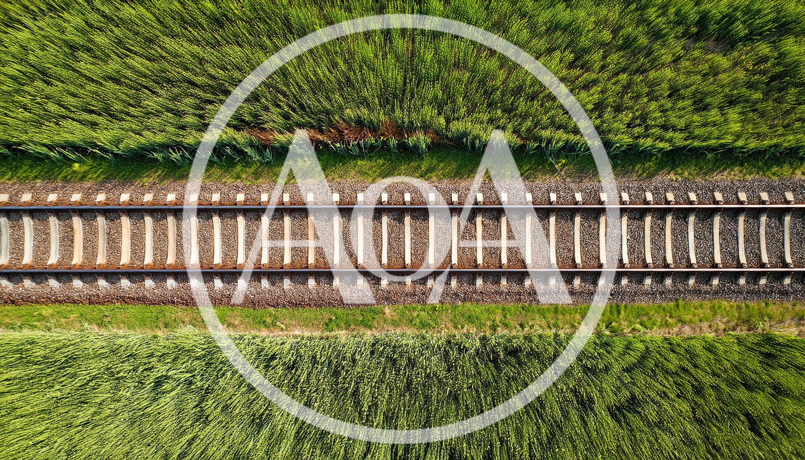 Aerial View Of Railway Tracks Through Green Fields