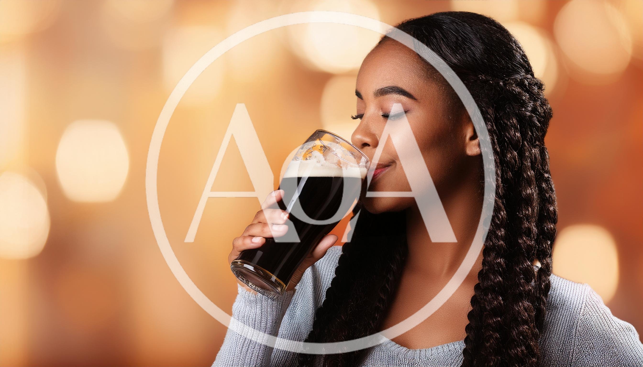 Young Woman Enjoying A Glass Of Dark Stout Beer