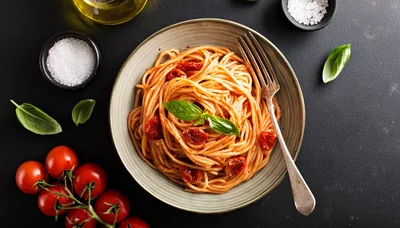 Spaghetti With Sun Dried Tomatoes In A Bowl