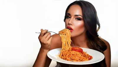 Beautiful Woman Eating Spaghetti With Tomato Sauce
