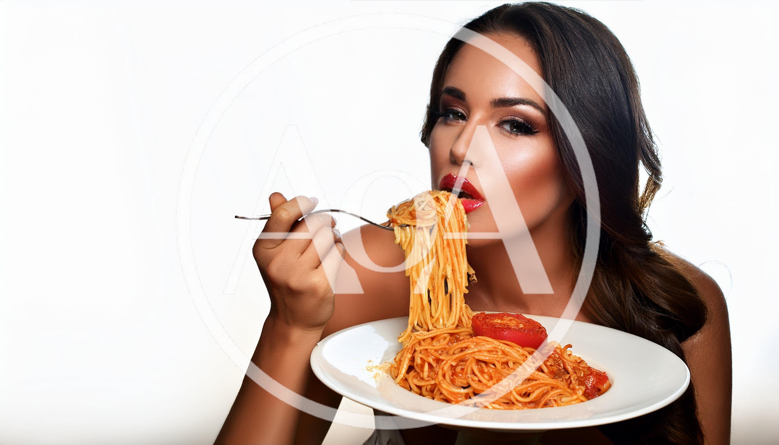 Beautiful Woman Eating Spaghetti With Tomato Sauce