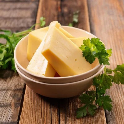 Chunks Of Yellow Cheese In A Ceramic Bowl