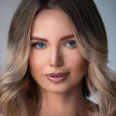 Portrait Of A Beautiful Blonde Woman With Blue Eyes