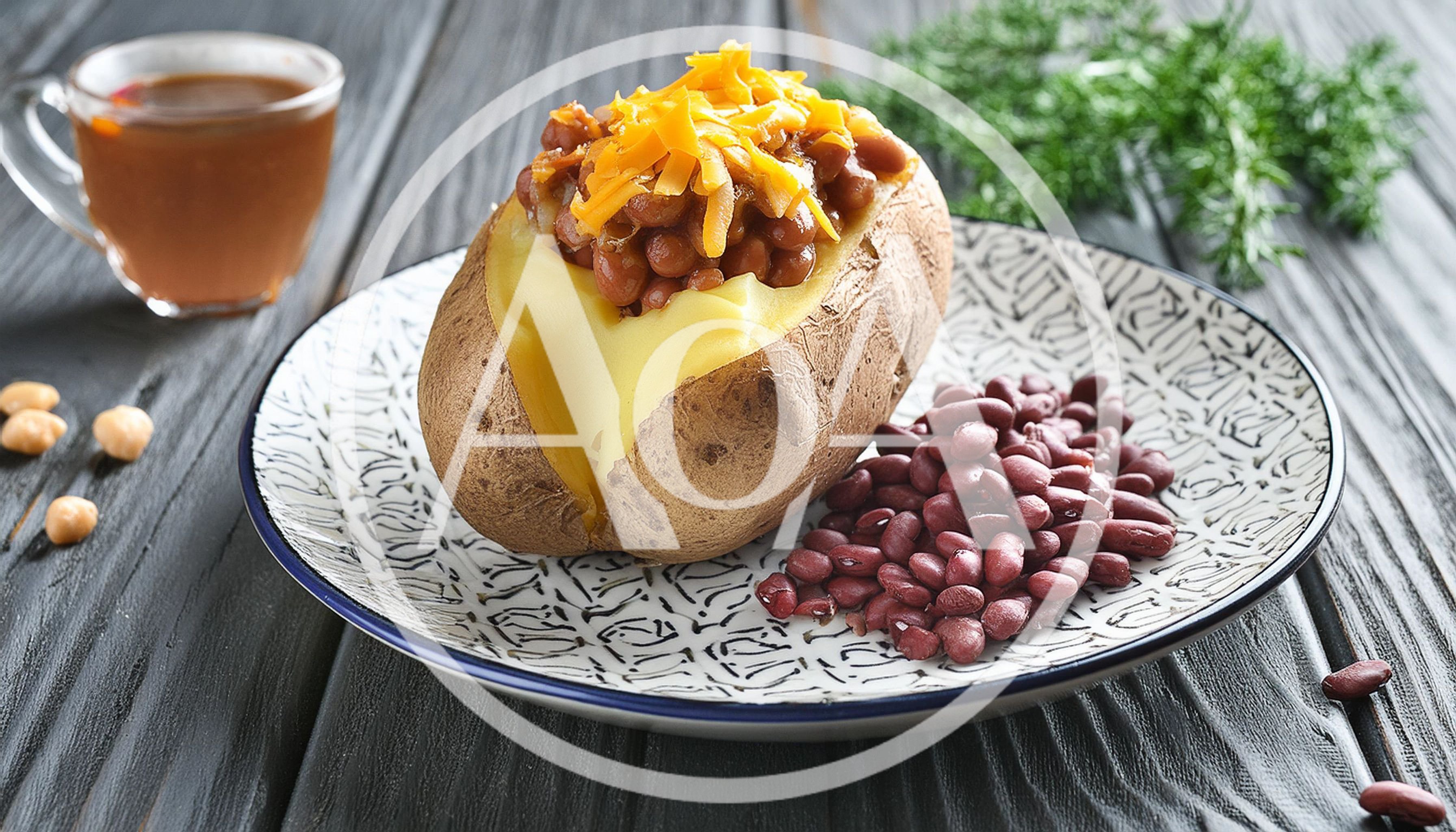 Baked Potato Topped With Beans And Shredded Cheese