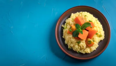 Couscous Salad With Carrots And Mint On Blue Background