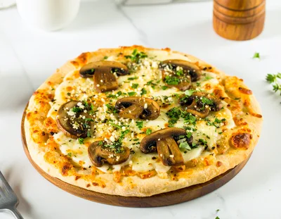 Freshly Baked Mushroom Pizza On A Wooden Board