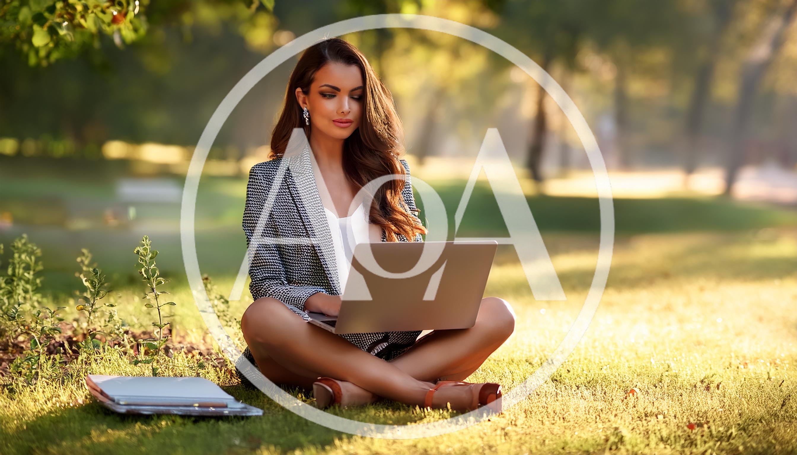 Businesswoman Working On Laptop In A Sunny Park