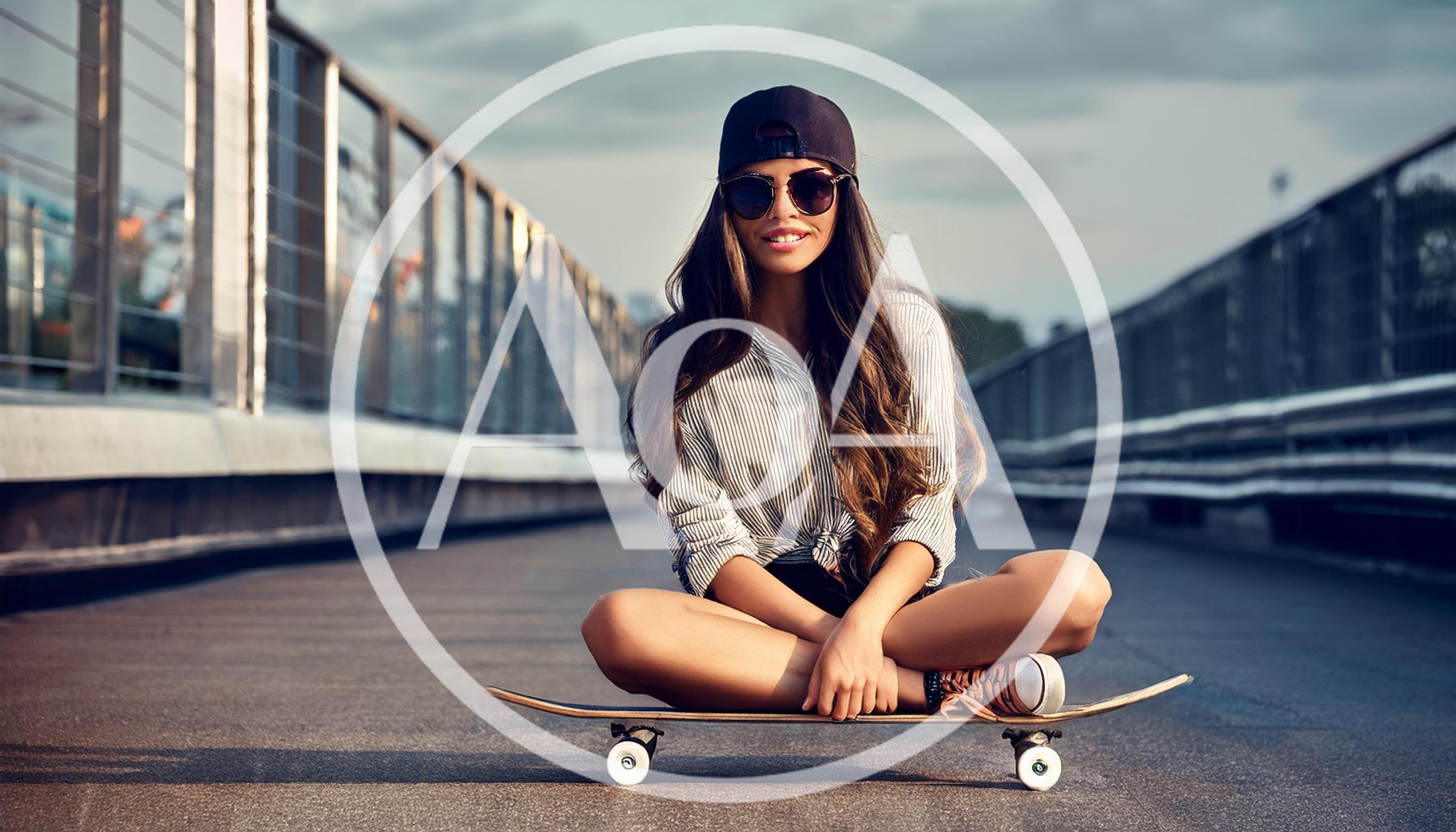Young Woman Sitting On A Skateboard Outdoors
