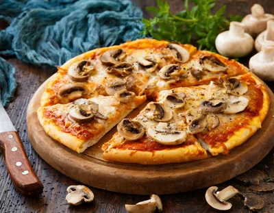 Fresh Mushroom Pizza On A Wooden Serving Board